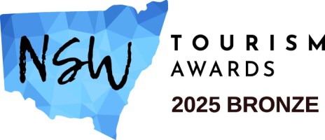 NSW Tourism Awards 2025 Bronze logo with blue map background.